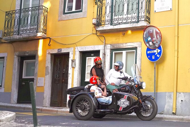 Lisbon El Cristo-Rei - Private Vintage Sidecar Tour - A historic square with church, aqueduct fountain, and 1974 politics