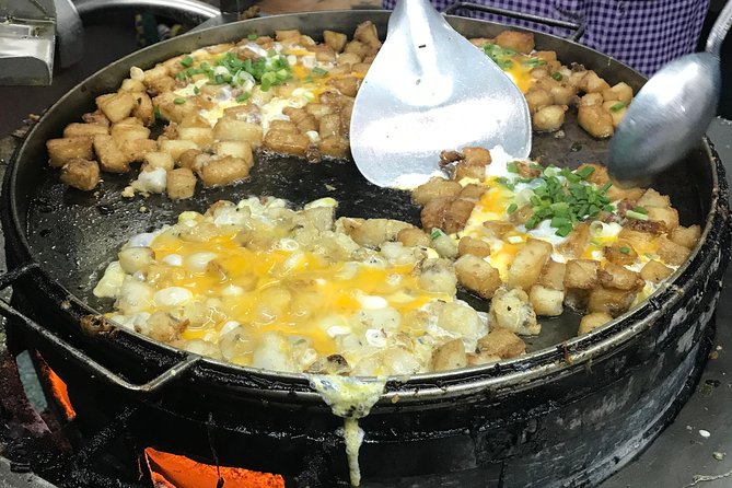 Private Ho Chi Minh Street Food Tour by Motorbike with Ao Dai Female Rider - An old apartment building, bread, and coconut ice cream