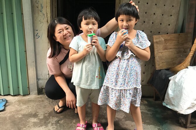 Saigon Slum tour and Saigon Chillspots by motorbike/ Aodai rider - A charity food stand and local flavors