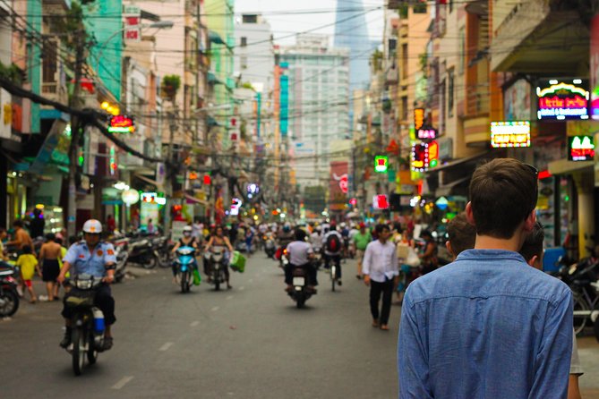 Small group Saigon Inside Out by Motorbike for 3 Hours - The theater and the city between stops